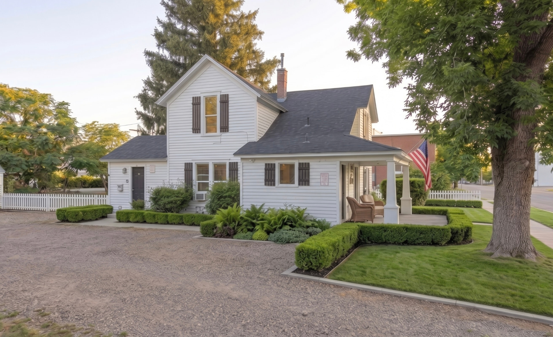 Rising Sun Nampa farmhouse-style home with trimmed hedges and gravel drive