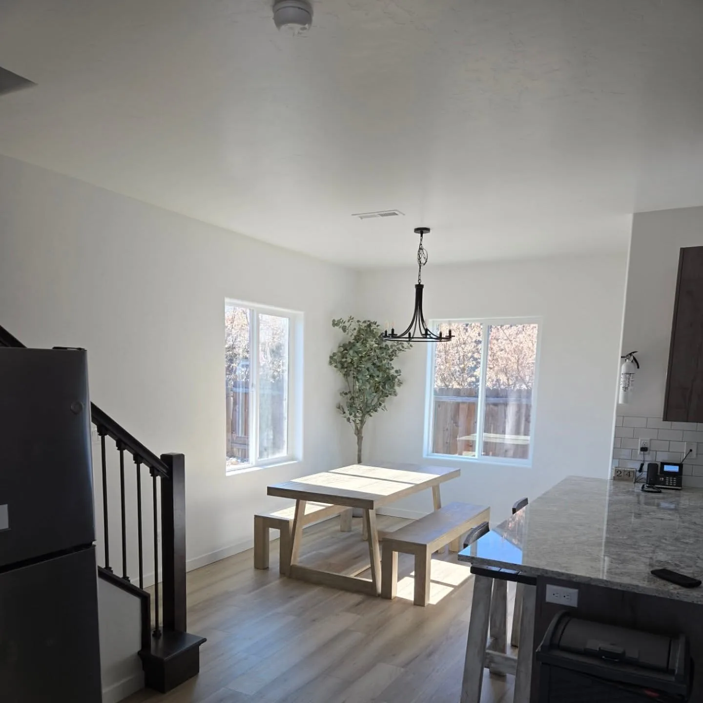 Bright dining area with farmhouse table and natural light
