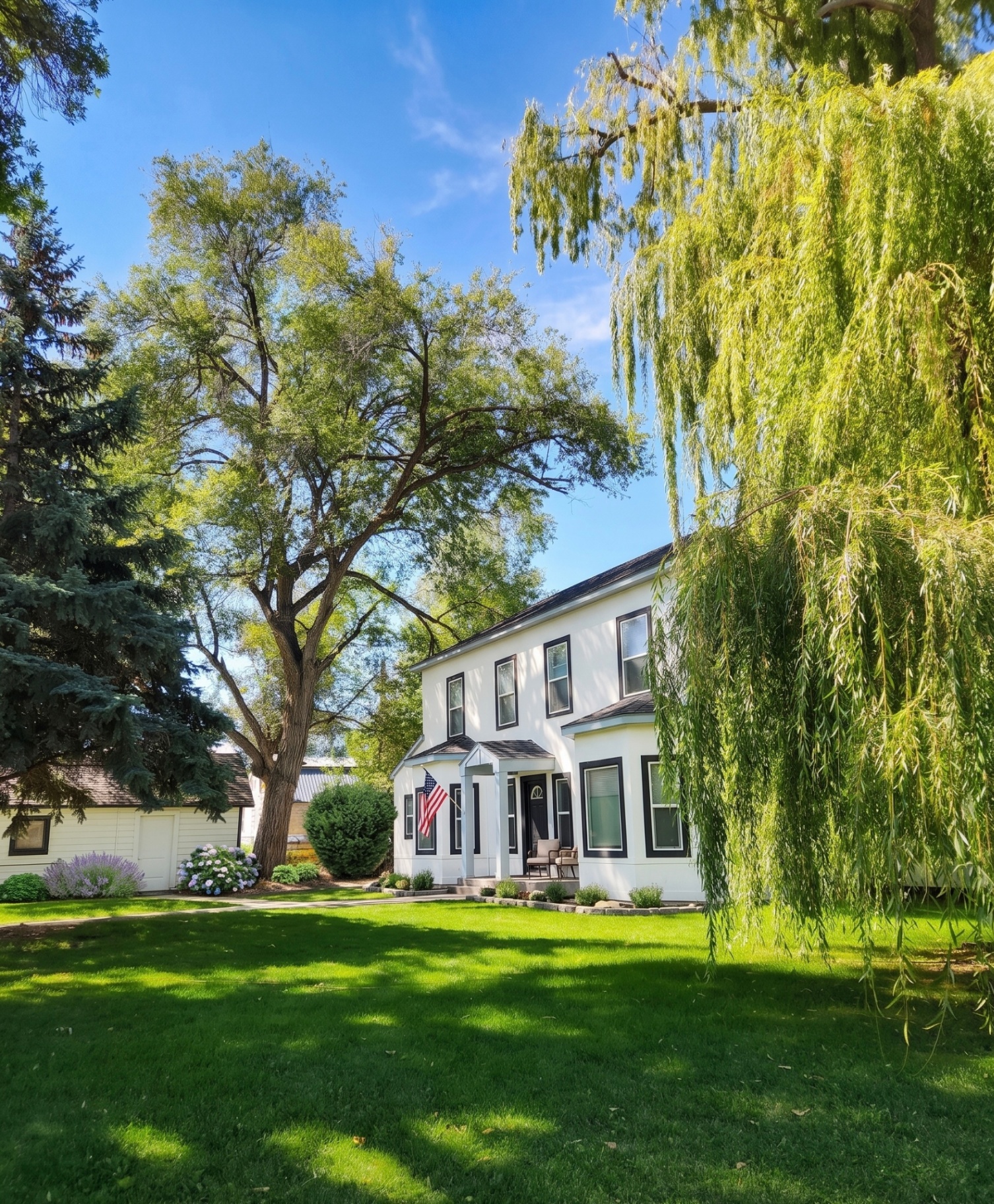 Rising Sun Idaho Falls home with willow tree and expansive lawn